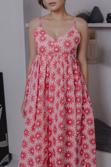 Close-up of red daisy block print on pink cotton silk dress fabric