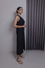 Side view of black handloom midi dress with flared hem and off-centre button closure