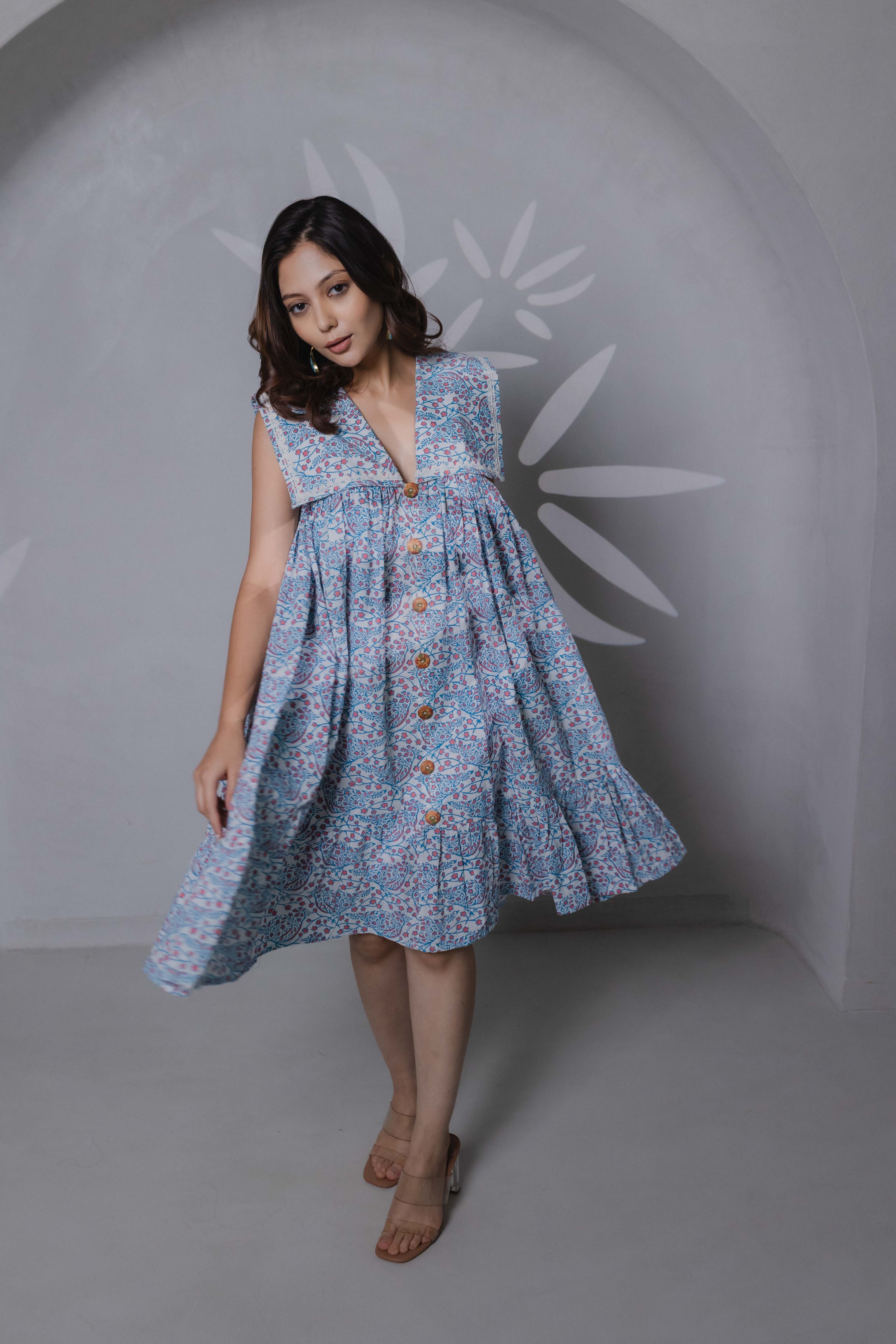 Close-up of bird block print and sailor collar detail on blue khadi cotton wooden button on front side