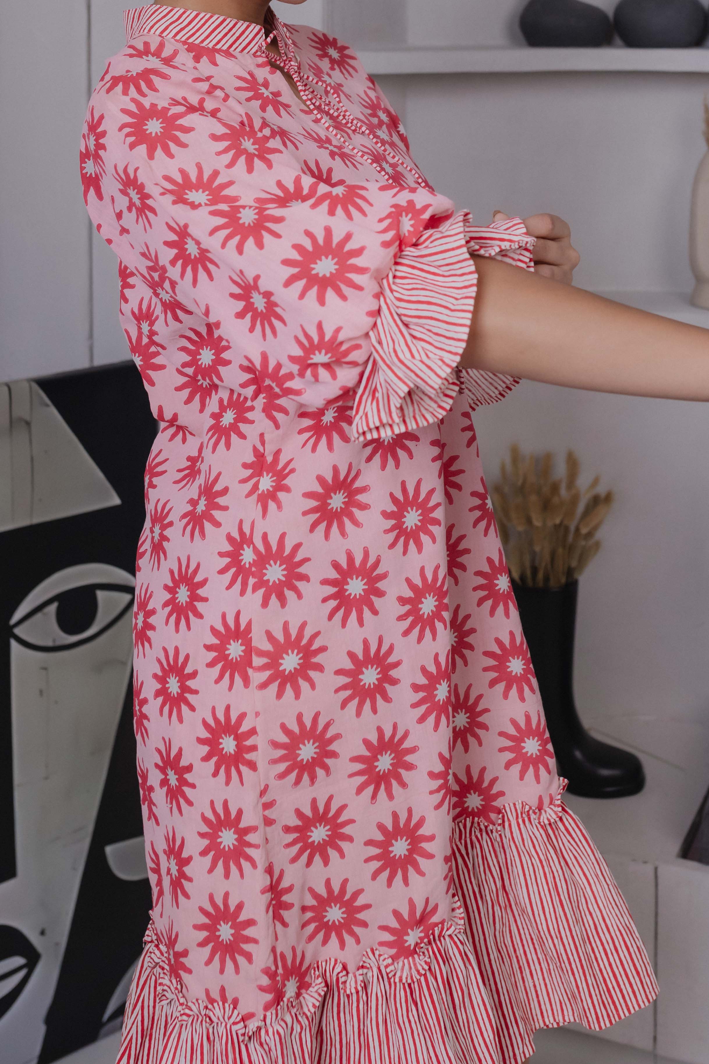 Close-up of pink floral block print on cotton silk with frill hem detail

