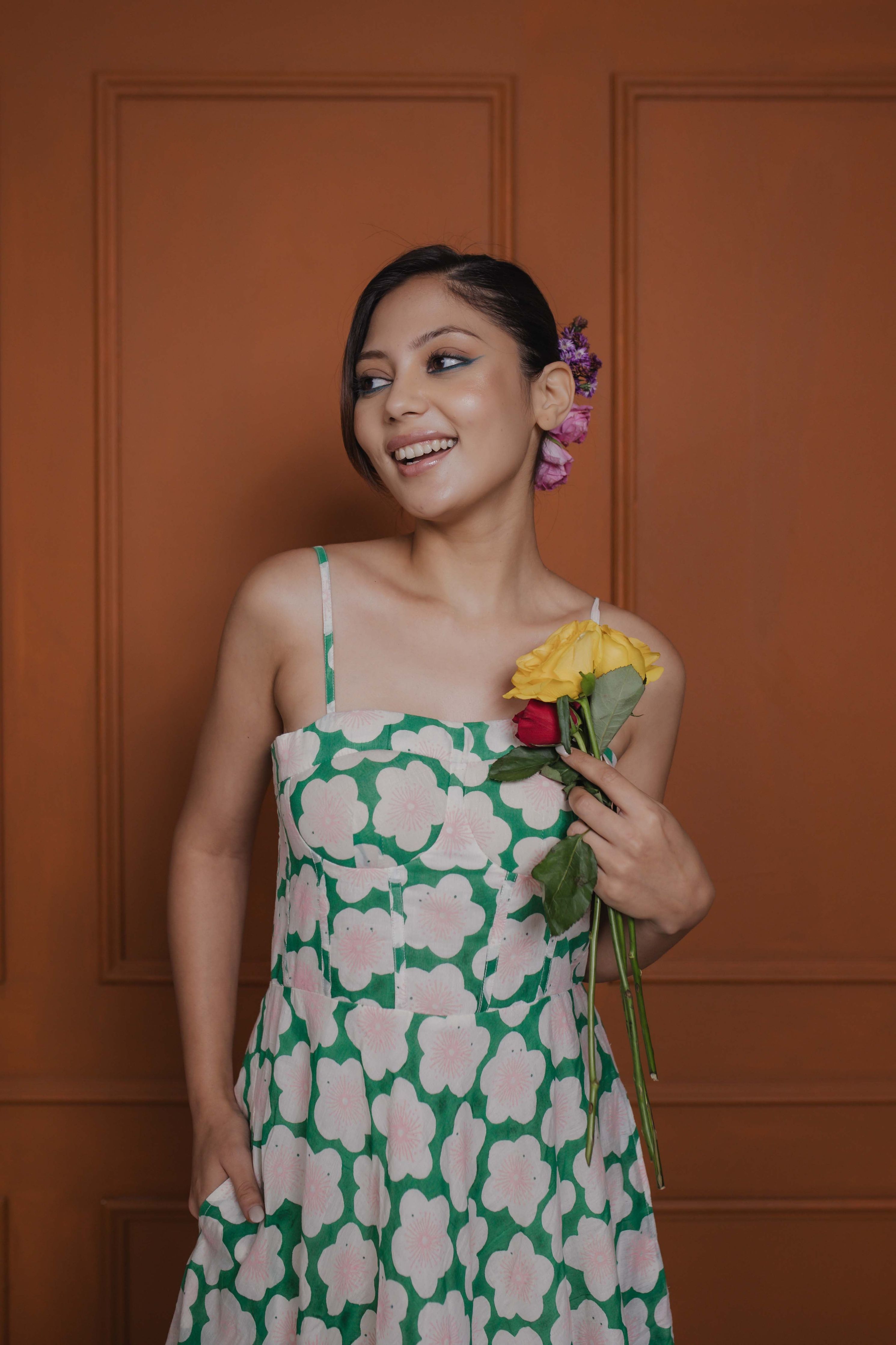 Close-up of floral block print on corset-style front of green cotton silk midi dress
