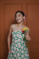 Close-up of floral block print on corset-style front of green cotton silk midi dress
